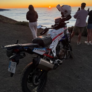 Motorcyclists admire the sunset over Teide, with a Honda Africa Twin 1100 at their side.